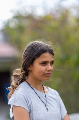 portrait of young aboriginal girl in vertical format with copy space - Australian Stock Image