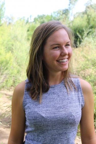 Portrait of young female outdoors with trees in background - Australian Stock Image