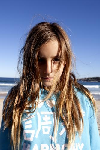 Portrait of young girl at the beach in winter - Australian Stock Image