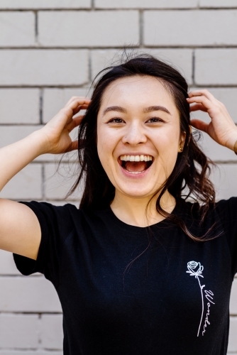 portrait of young, laughing asian woman