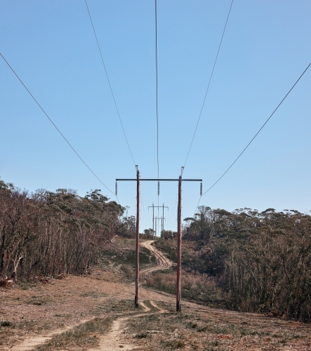 Power lines running through cleared bushland - Australian Stock Image