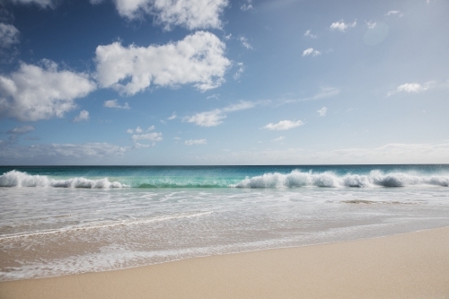 Pristine beach looking out to sea in morning light - Australian Stock Image