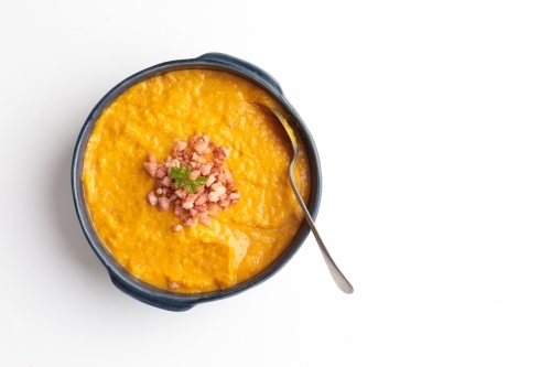 Pumpkin soup bowl with bacon chips - Australian Stock Image