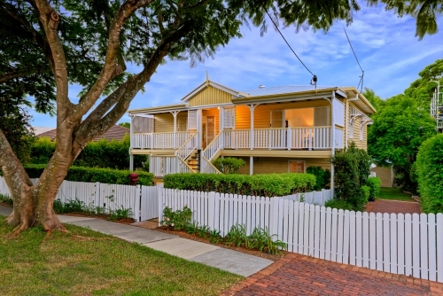 Queenslander home in Brisbane photographed at dusk - Australian Stock Image