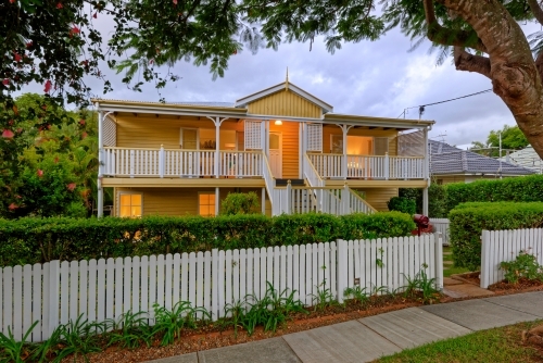 Queenslander home in Brisbane photographed at dusk - Australian Stock Image