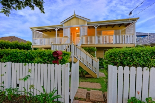 Queenslander home in Brisbane photographed at dusk - Australian Stock Image