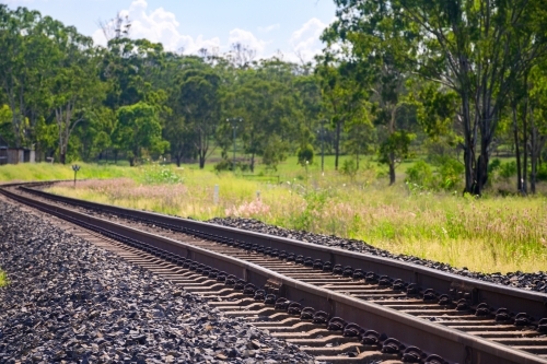 Rail tracks in Queensland countryside during summer - Australian Stock Image