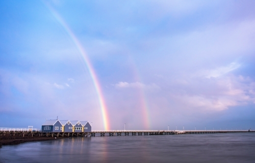 Rainbow after the rain over Busselton jetty, the longest wooden jetty in the Southern Hemisphere - Australian Stock Image