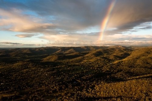 Rainbow over granite belt mountain landscape - Australian Stock Image