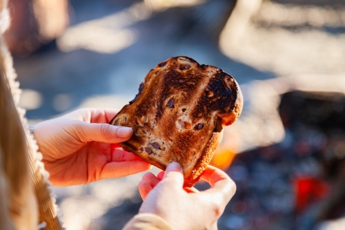 Raisin toast cooked over campfire outside - Australian Stock Image