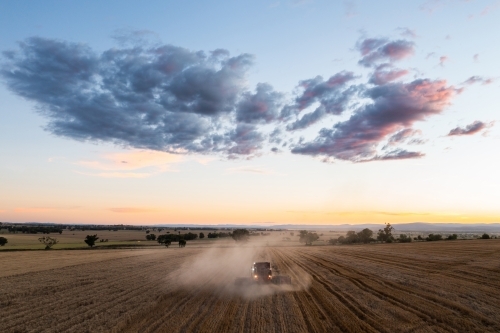 Rear view of combine harvester at dusk - Australian Stock Image