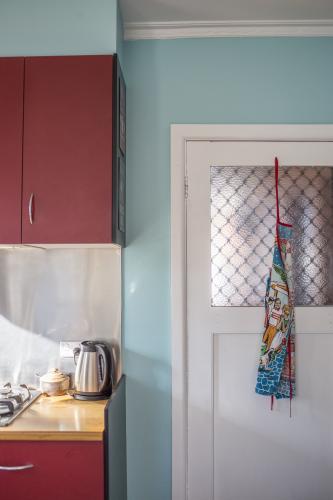 Red and teal kitchen interior - Australian Stock Image