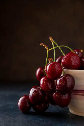 red ripe cherries on a plate - Australian Stock Image