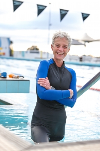 Relaxed active senior lady at swimming pool - Australian Stock Image