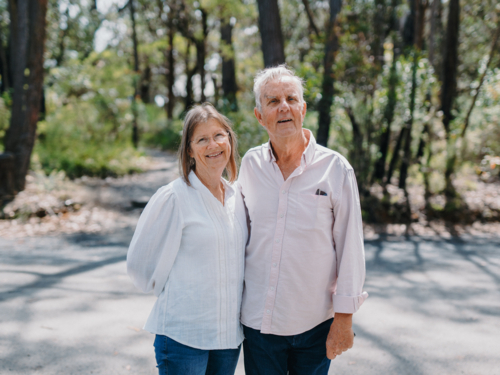 Retired senior couple standing together enjoying healthy lifestyle in aussie bushland - Australian Stock Image