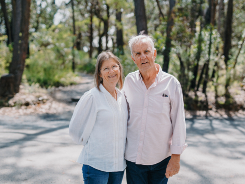 Retired senior couple standing together enjoying healthy lifestyle in nature - Australian Stock Image