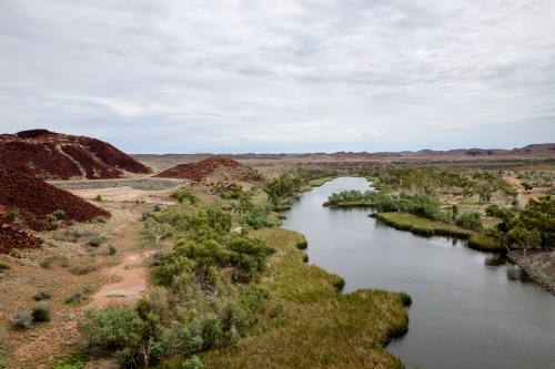 river in the Pilbara under cloudy sky - Australian Stock Image