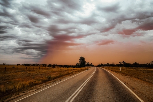 Road in the outback with overcast sky - Australian Stock Image