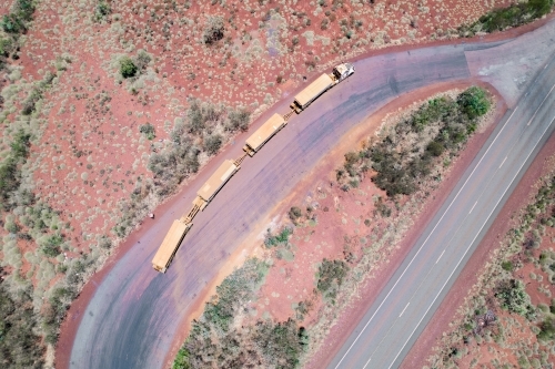 Road train stopped at a truck resting area next to the asphalt road - Australian Stock Image