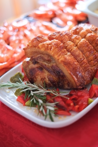 Roast pork served feast style with prawns - Australian Stock Image