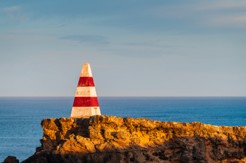 Robe Obelisk during sunrise viewed from the walking trail, Limestone Coast, South Australia - Australian Stock Image