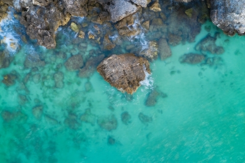 Rock in clear ocean water at the Henderson Cliffs near Perth, Western Australia. - Australian Stock Image