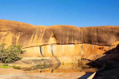 Rock pool and wave formation at Beringbooding Rock - Australian Stock Image