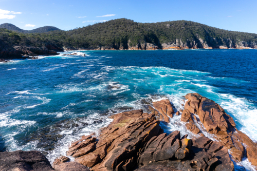 Rocks and waves at Sleepy Bay, Tasmania - Australian Stock Image