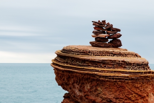 rocks piled on layered rock - Australian Stock Image