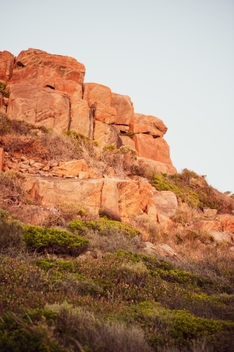 Rocky cliff view of rugged coastline at sunset - Australian Stock Image