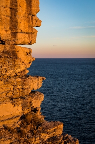 Rocky sea cliffs at sunset - Australian Stock Image