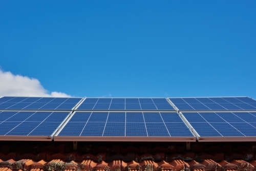 Rooftop solar panels under blue sky - Australian Stock Image