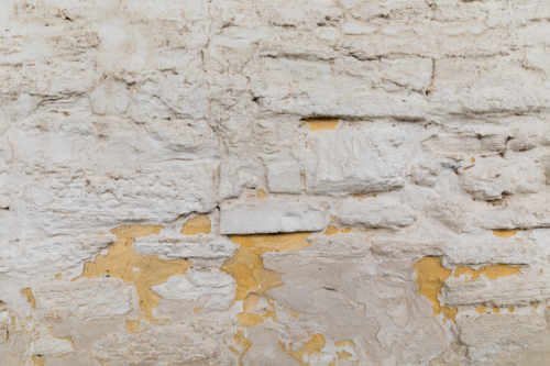 Rough white rendered stone brick wall - Australian Stock Image