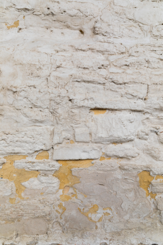 Rough white rendered stone brick wall - Australian Stock Image