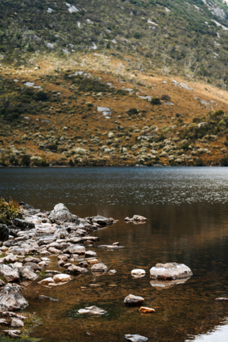 Rounded rocks on the shallows of the lake - Australian Stock Image