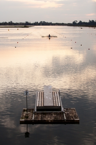 Rowers training on a lake in the evening - Australian Stock Image