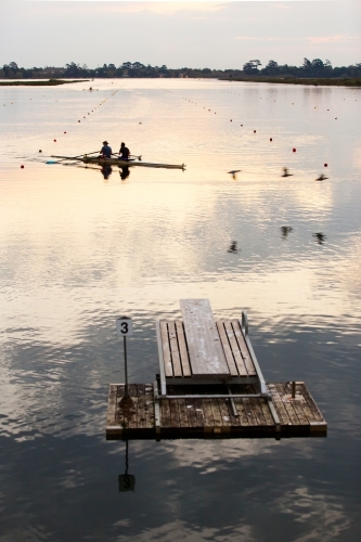 Rowers training on a lake in the evening - Australian Stock Image