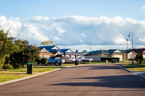 Rubbish and green bins out on quiet town street awaiting collection - Australian Stock Image