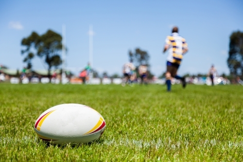 Rugby ball on with edge of the playing field during a game - Australian Stock Image