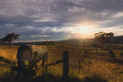 Rural mailbox on ridgeline in regional New South Wales with sun setting in background - Australian Stock Image