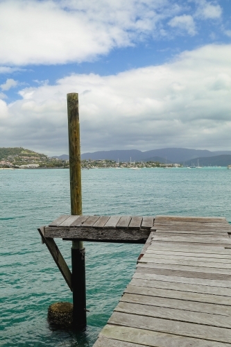 Rustic wooden jetty at Mandalay off Airlie Beach - Australian Stock Image