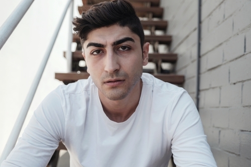 Sad multicultural young adult man - Australian Stock Image
