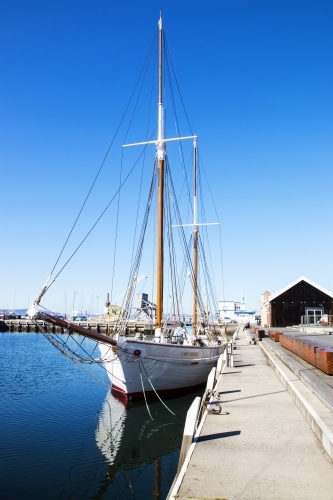 Sailboat docked at wharf - Australian Stock Image