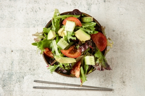 salad with greens, tomato, and avocado - Australian Stock Image