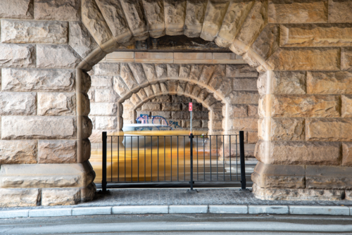 Sandstone arches at Eddy Ave, Central Station with blurry cars driving past - Australian Stock Image