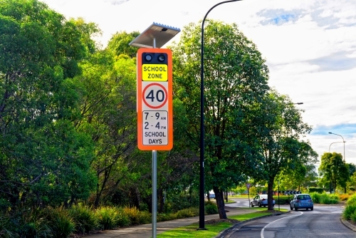 School zone warning sign with 40 km signal lights on the side of the road - Australian Stock Image