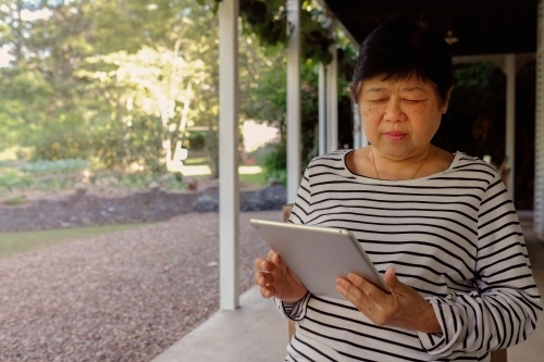 Senior Asian woman using tablet