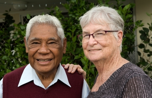 Senior couple standing together outdoors looking at the camera. - Australian Stock Image