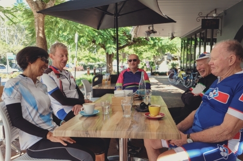 Senior cyclists having coffee after bike ride - Australian Stock Image