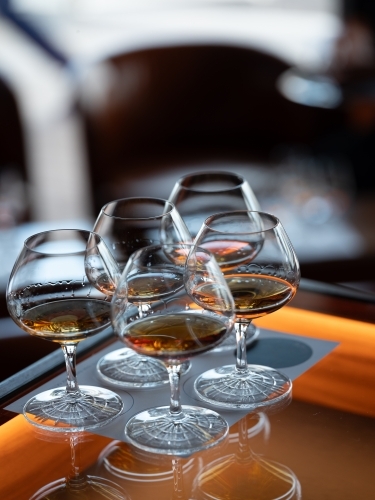 Series of glass wares filled with whisky for tasting - Australian Stock Image